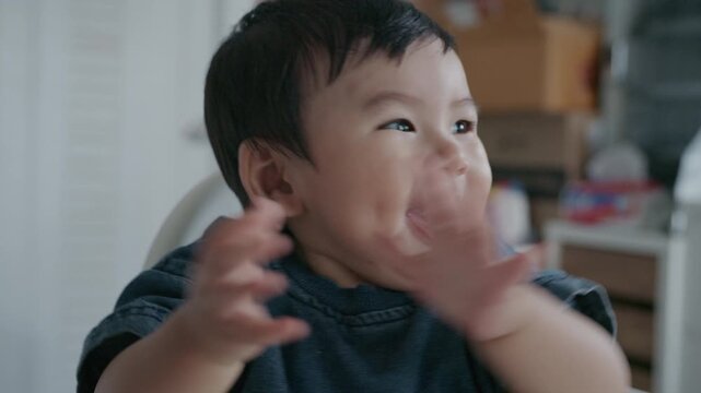 Cute Asian baby boy smiling happily and reaching hand towards camera.4K