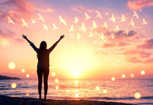 Silhouette of a person with open arms at sunset with birds flying around peaceful scene