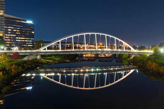 Main Street Bridge arch reflecting on Scioto River at night