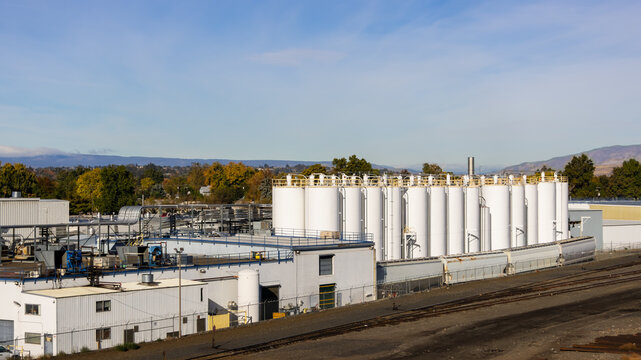 Industrial facility with multiple white storage tanks