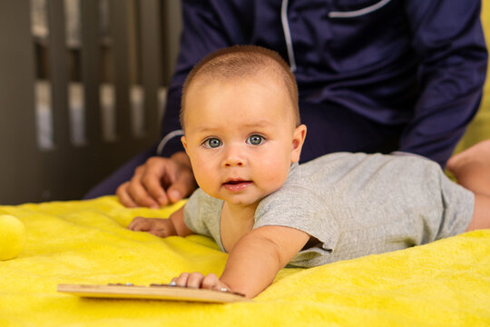 Curious Infant Reaching Forward During Supervised Tummy Time