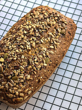Angled View Of Seeded Keto Bread On Cooling Rack