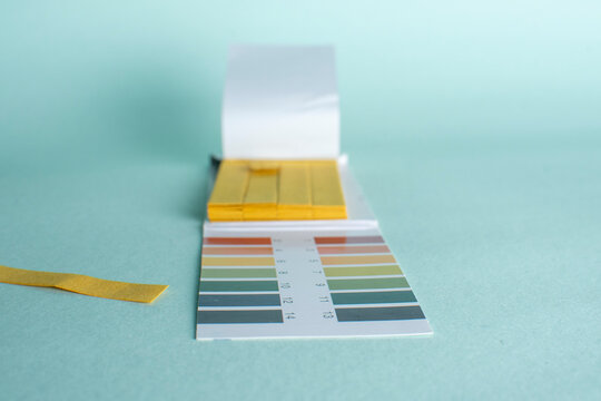 pH test paper indicator strips booklet with color scale for acidity and alkalinity measurement
