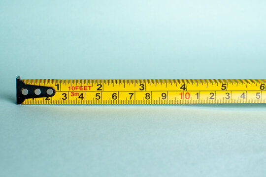 Yellow measuring tape lying horizontally representing distance dimension evaluation and size