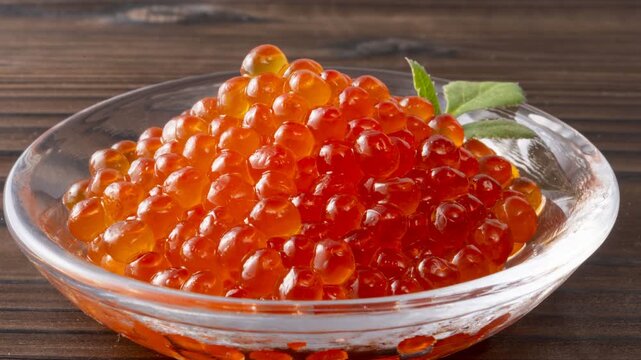 Fresh Japanese ikura salmon roe marinated in soy sauce served on wooden spoon