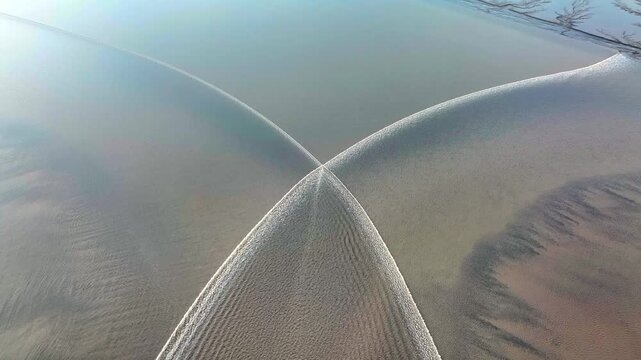 Aerial drone view of natural sandbar patterns and ripples in shallow river water