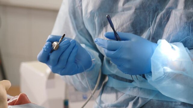 Surgeon blue gloved hands removing sterile dental implant from packaging box. Final preparation step before adult tooth implantation procedure. Precise surgical manipulation for patient oral health 4k