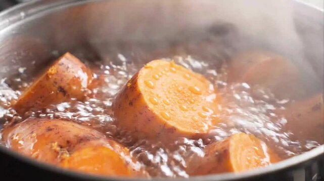Sliced Sweet Potatoes Boiling in Pot of Water with Steam