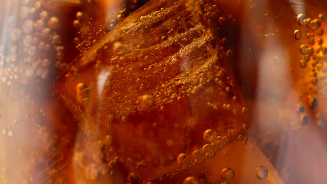 Macro Close Up of cola bubbles and ice cubes background