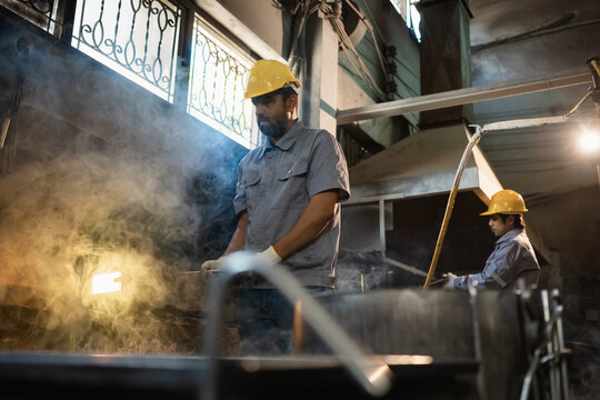 foundry steel melt with worker factory; workers in a foundry. foundry guides buyer choices, steel frames the scene, and melt adds useful meaning. Clear visual context supports stock buyers.