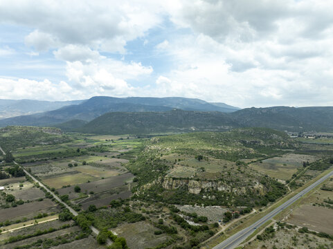 Aerial view of the rugged landscape and agricultural fields surrounding the mezcal production region in Santiago Matatlan, Oaxaca, Mexico.