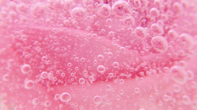 Pink serum gel background, cream, shampoo, macro soap bubbles, foam texture