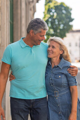 Fototapeta premium Smiling mature couple standing close together outdoors