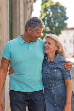 Smiling mature couple standing close together outdoors