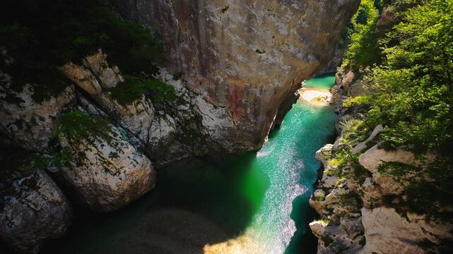 Turquoise mountain stream water in the rocky Cellina gorge from Sentiero del Dint trail, Italy.