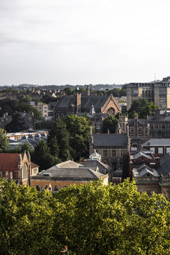 Aerial view of the historic University of Bristol campus buildings surrounded by lush green trees and urban architecture in Bristol, England, United Kingdom.