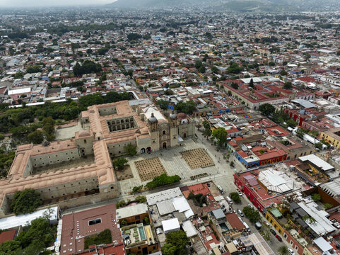 Aerial view of the historic Temple of Santo Domingo de Guzman surrounded by colonial architecture, red-tiled rooftops, and urban streets in Oaxaca de Juarez, Oaxaca, Mexico.