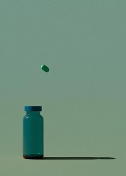 Small blue glass bottle with a blue cap. the bottle is placed on a light green background. in the center of the image, there is a single green pill that is falling off the top of the bottle.