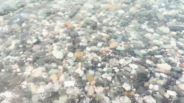 Blue sea and large waves and foam. Wave splashing over pebbles at sea. Rolling ocean waves. Summer beach background. Powerful sea waves	