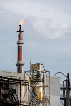Industrial Gas Flare Stack Burning at Oil Refinery with Copy Space