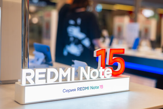 Smolensk, Russia 08.05.2026. A retail store in Russia features a display for the Redmi Note 15 smartphone. Customers explore various tech products as the staff assist them in the background