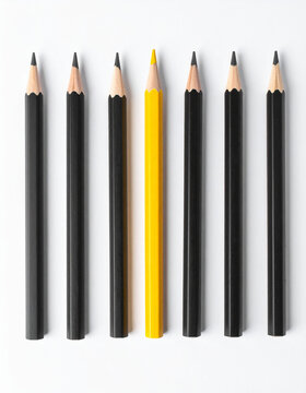 Single vivid yellow pencil among black pencils, white background. Individuality, uniqueness and being different, clean minimalist composition. Close-up.