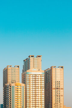 New Residential Multi-storey Houses. Cityscape Skyline In Sunny Spring Evening On Blue Sky. Real Estate, Development Industry. UAE