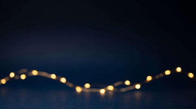 Warm bokeh string lights creating a festive holiday background atmosphere