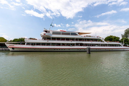 Wide side profile of a white passenger ferry boat named Vorarlberg docked at a port on Lake Constance