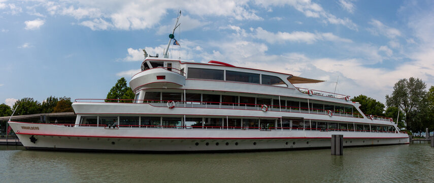 Wide side profile of a white passenger ferry boat named Vorarlberg docked at a port on Lake Constance