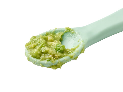 Fresh mashed avocado puree spoon feeding organic baby food isolated on black background for healthy infant diet nutrition weaning recipe snack guacamole green vegetable dip closeup shot