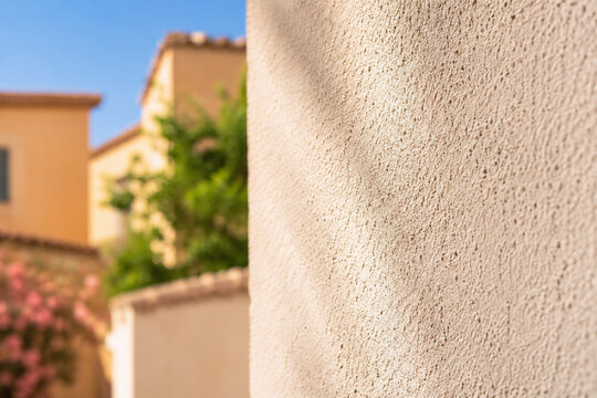 Feine Putzstruktur an mediterraner Hausfassade im Sonnenlicht