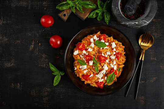 Greek Kritharaki Orzotto with Tomatoes, Feta Cheese and Fresh Basil. Top view