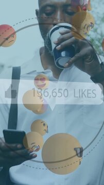 Thumbs up icon with increasing likes and face emojis against african american man drinking coffee