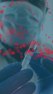 Dna structure spinning over male doctor wearing face mask tapping on syringe to remove air bubbles