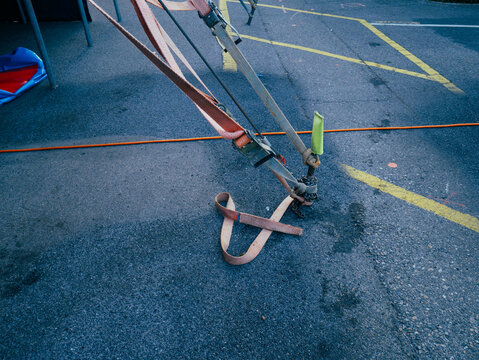 Circus tent guy lines metal stakes and tension straps on asphalt ground outdoor setup safety equipment rigging