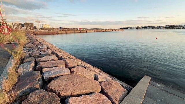 Rocky Breakwater and Calm Sea in Evening Light Helsinki