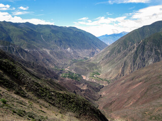 A beautiful mountain valley with clear blue sky and white clouds © Gloream