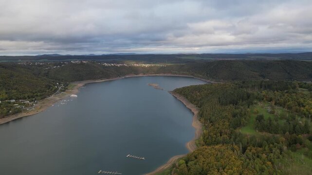 Panoramic aerial view of Edersee lake in Germany, nestled in the Hesse region, with Waldeck-West on its shore and Hammerbergspitze mountain in the background. Scenic nature landscape.