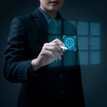Executive taps a digital user profile icon on a futuristic virtual interface using a sleek touchscreen pen.
