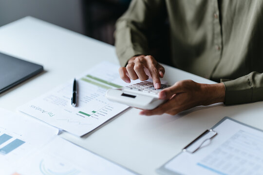 Businessman reviewing company documents and financial reports at office desk