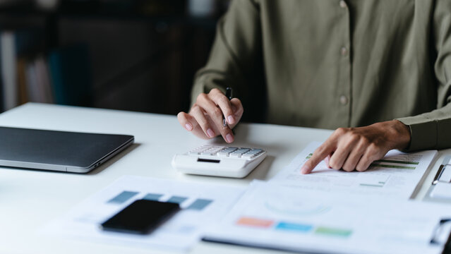 Businessman reviewing company documents and financial reports at office desk