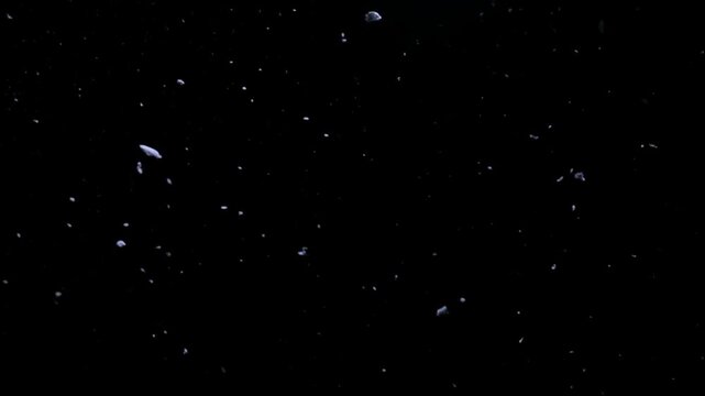 Cinematic space debris floating in dark void, realistic asteroid field in deep cosmos, cosmic dust and rock fragments background