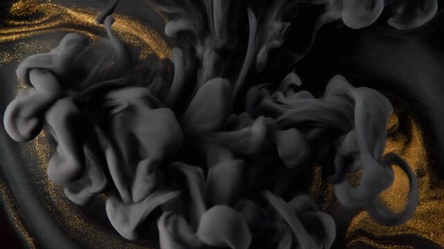 Onyx-black ink blooms through clear liquid, fine gold-toned tendrils threading through dark diffusion under dramatic side lighting, creating glossy contrast, opulent texture, and luxurious abstract mo