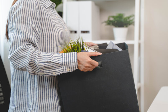Resigned from work. female employee packing stuff to leave the job
