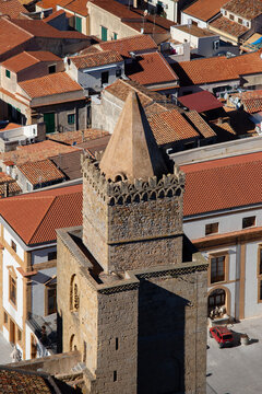 The Norman Cathedral of Cefalu stands majestically with its imposing stone facade.