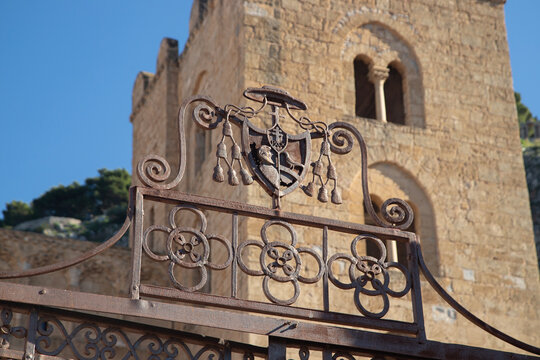 The Norman Cathedral of Cefalu stands majestically with its imposing stone facade.