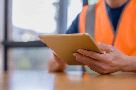 worker using a digital tablet for inventory management and logistics, showcasing smart technology, supply chain operations, stock control, productivity, and modern industrial workflow.
