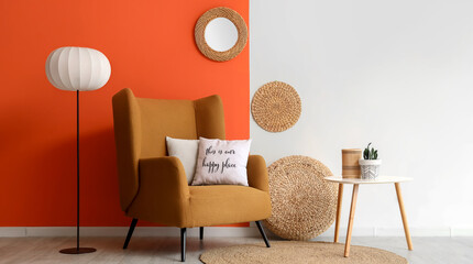 Obraz premium Cozy living room interior with a mustard armchair, floor lamp, and decorative elements against a two-tone wall
