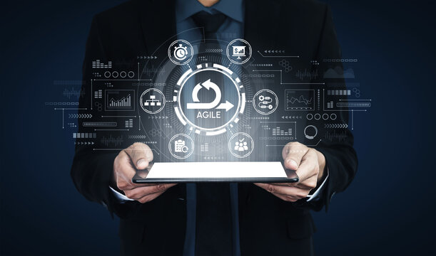 Business Man Holding Tablet with Agile Graphic, Digital Transformation Concept, Management Strategy and Innovative Technology Solutions Displayed. Entropy.